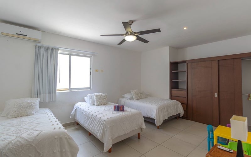 Bedroom with three beds